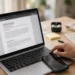 Person pressing keyboard screenshot shortcuts on a laptop with a smartphone showing a screen-capture frame beside it